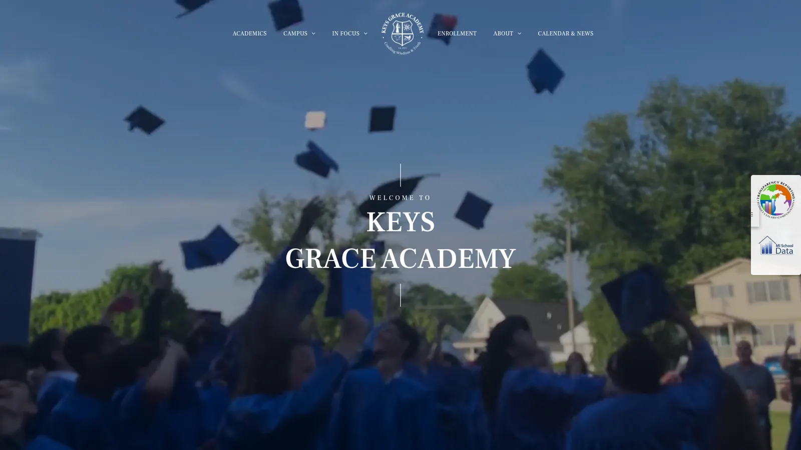 KEYS Grace Academy homepage: 'Welcome to KEYS Grace Academy' over a photograph of graduates throwing caps into a blue sky, with a centered school crest in the navigation.